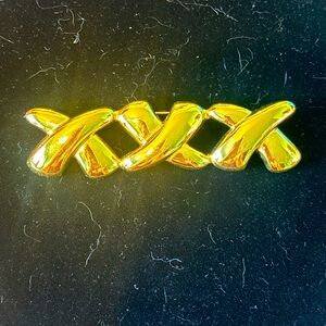 Gold tone XXX brooch
